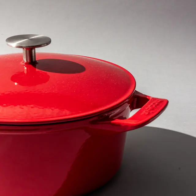 Red dutch oven on a grey background
